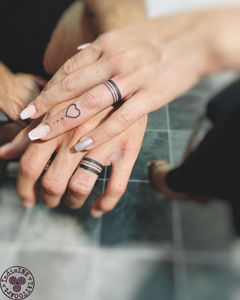 30+ Unisex Wedding Ring Tattoos for Couples - AI Tattoo Lab Tattoo Ring Finger Ideas, His And Hers Tattoos Marriage, Couple Tattoos For Finger, Ring Tattoo Ideas Women, Married Couple Hand Tattoos, Womens Wedding Ring Finger Tattoo, Top Finger Tattoo, Wedding Bands For Women Tattoo, Marriage Hand Tattoo