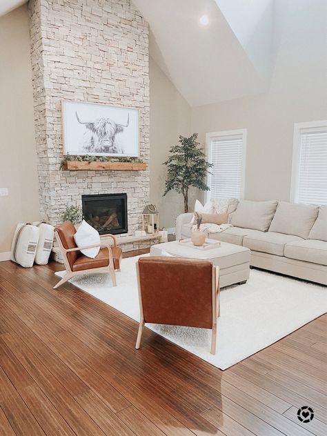 Bull Pictures Decor Living Room, Fireplace With Chairs On Each Side, White Couch And Accent Chairs, Frame Tv Over Stone Fireplace, Frame Tv On Stone Fireplace, White Couch With Accent Chairs, Chairs By Fireplace, Cream Couch Living Room, Floor Pillows Living Room