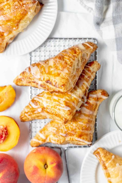 Using fresh peaches and store-bought puff pastry, you can whip up these easy Peach Turnovers in no time, making them ideal for any occasion! If you're craving a quick and delicious summer dessert, this peach turnover recipe is sure to be a hit with everyone! Peach Pastries Recipes, What To Do With Frozen Peaches, Peach Recipes With Puff Pastry, Southern Pastries, Peach Strudel Recipes, Ripe Peaches Recipes, Recipes With Puff Pastry Desserts, Peach Dessert Recipes With Fresh Peaches, Peach Danish Recipe