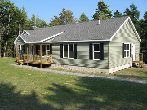 Modular ranch exterior with green siding and black shutters. Tan House Green Trim Exterior Colors, Green Siding Black Shutters, Green House With Black Shutters, Green Siding Black Roof, Olive Green House Exterior Black Trim, Green House With Shutters, Green House Black Shutters, Green Ranch House Exterior, Green Vinyl Siding House