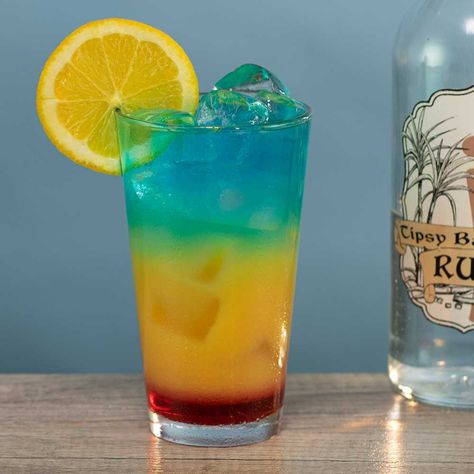 This here is the Barbados Surprise, and if there's anything shocking about this Caribbean-themed drink it's how crazy beautiful it is. Tipsy Bartender Jungle Juice, Tipsy Bartender Drinks, Tipsy Bartender Recipes, Grenadine Cocktail, Tropical Cocktail Recipes, Bartender Recipes, Frozen Drinks Alcohol, Rum Drinks Recipes, Alcoholic Punch Recipes