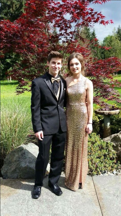 Black Tux With Gold Bow Tie, Black Tux With Gold Accents, Gold Prom Dress And Suit, Black And Gold Tuxedo Prom, Black Suit With Gold Tie, Black And Gold Suit Men Prom, Gold Prom Tux, Black Suit With Gold Accents, Black And Gold Prom Couple