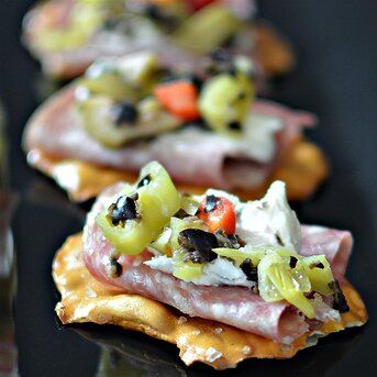 Muffaletta Pretzel Crisps® Recipe | Allrecipes Pretzel Crisps Recipe, Lemon Cello Recipe, Muffaletta Recipe, Muffaletta Sandwich, Party Mix Snacks, Methi Recipes, Crisps Recipe, Muffuletta Sandwich, Pretzel Crisps