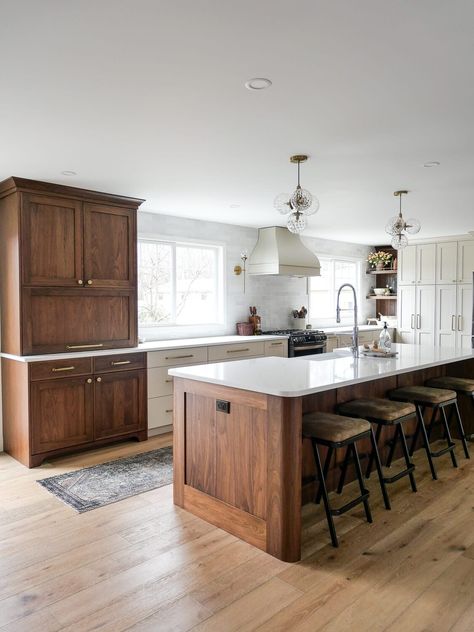 Walnut kitchen cabinets are trending. But should they be? Learn the pros and cons of walnut kitchen cabinets, plus some current design ideas! #walnutkitchen #walnutcabinetry #walnutkitchendesign #kitchendesign #walnutcabinets #kitchendesignideas #woodkitchencabinets All Wood Island, White Bottom Cabinets Dark Top Cabinets, Wood Stain Cabinets Kitchen, Kitchens With Cherry Wood Cabinets, Brown Cabinets White Counter, Walnut Cabinets Kitchen, Dark Wood Island, Wood Top Kitchen Island, Grace In My Space