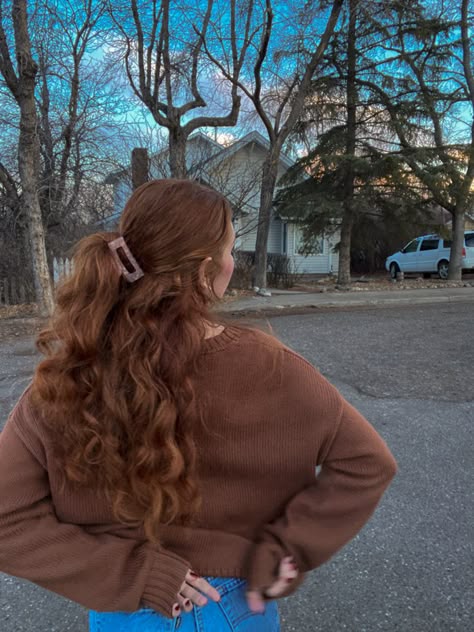 a picture of a womens back. she is wearing a brown cardigan and you can see her hands behind her back, she has on red nail polish. she has long wavy red hair pulled in a half up half down type style with a small pink claw clip. in the background you can see trees and a house Naturally Wavy Red Hair, Auburn Hair Woman Character Inspiration, Prom Dresses Ginger Hair, Wavy Red Hair Natural, Redhead Character Inspiration, Long Red Hair Aesthetic, Long Curly Ginger Hair, Auburn Hair Aesthetic, Curly Red Hair Aesthetic