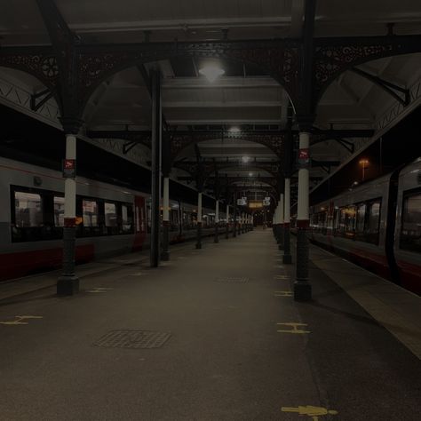 train station at night, low light looking down platform with trains on either side Abandoned Train Station Aesthetic, Time Travel Aesthetic Dark, Dark Train Station, Train Station Underground, Grunge City Aesthetic, Train Station Design, Grunge Photography Aesthetic, Train Station Aesthetic, Luminal Space