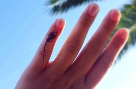 The Delicate Feather Peacock Feather Tattoo On Finger, Tattoo Ideas For Fingers, Radha Tattoo, Tattoo Krishna, Best Finger Tattoos, Diamond Finger Tattoo, Flute Tattoo, Tattoos Feather, Tiny Finger Tattoos