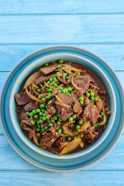 Chamorro Bistek - Dive into the rich culinary heritage of Guam with Chamorro Bistek! 🌴✨ Savour the unique blend of flavours in this tantalizing beef stew served over fluffy white rice. #ChamorroCuisine #GuamFood.  Experience the vibrant flavours of Chamorro cuisine with Chamorro Bistek, a tantalizing beef stew infused with annatto seeds extract and... Chamorro Bistek Recipe, Bistek Recipe, Fluffy White Rice, Annatto Seeds, Chamorro Recipes, Rice Soup, Saute Onions, Filipino Recipes, Frozen Peas