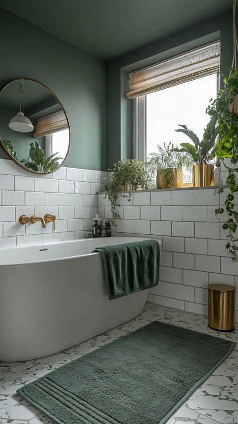 Modern bathroom featuring white and green tiles, a large round mirror, plants in a vase, and a green velvet towel. White And Dark Green Bathroom, Green Bathroom With White Tile, Mirror Above Bathtub, White And Green Tile Bathroom, Bathroom White And Green, Olive Green And Gold Bathroom, Bathroom Decor Green Walls, White Tile Green Wall Bathroom, Green And Gold Master Bath