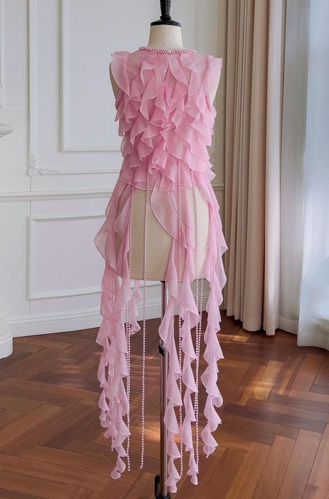 Elevate your look with the ultra-chic Pink Ruffle and Pearl Fringe Draped Crop Top. This trendy top features soft, cascading ruffles that add a touch of playfulness and femininity. The delicate pearl fringe drapes gracefully along with the ruffles, creating a luxurious and eye-catching effect with every movement. The draped design flatters the figure, giving you a polished yet effortlessly stylish look. Whether paired with jeans for a casual day out or styled with a skirt for a night on the town, this crop top is perfect for making a statement. Ideal for fashion-forward individuals looking to add a touch of elegance and charm to their wardrobe. * Sizing - All items are made according to measurement ranges, therefore, do not order your normal letter or numeric size as all sizes will vary de Pearl Crop Top, Pearl Skirt, Pearl Fringe, Mermaid Top, Fringe Crop Top, Butterfly Costume, Flamingo Dress, Sculptural Fashion, Costume Inspo