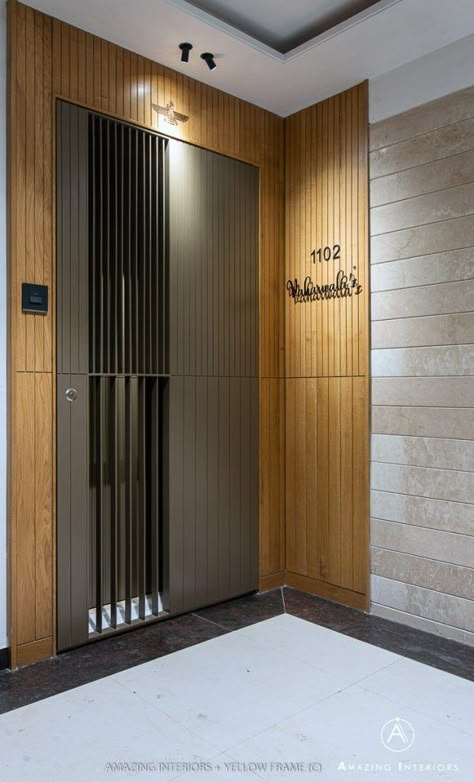 A Subtle 3BHK Apartment Complementing An Elementary Lifestyle | Amazing Interiors - The Architects Diary Front Door Paneling Entrance, Entrance Paneling Design, Main Enterence Design, Main Entry Gate Design, Entrance Door Design Apartment Modern, Main Door Paneling Design Entrance, Entrance Door Panelling, Entrance Panelling Design, Jaali Door Design