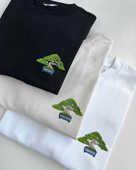 Wearable art BONSAI🌳 This embroidery design features a detailed mini bonsai tree, perfect for the left chest or center placement. Available in 16 colors for hoodies, sweatshirts, and t-shirts, so you can find your favorite one. Our premium clothing is made from thick, 100% organic cotton, ensuring durability and a sustainable choice. Mini Bonsai, Bonsai Tree, Wearable Art, Embroidery Design, Design Features, Embroidery Designs, Organic Cotton, Finding Yourself, T Shirts