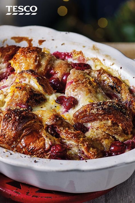 Transform your Christmas leftovers into this luxurious cranberry croissant bread and butter pudding. Stale croissants and that spare half jar of tangy cranberry sauce are soaked in rich orange custard for a cosy, comforting pud. | Tesco Panettone Pudding, Christmas Panettone, Christmas Leftovers, Croissant Bread, Butter Pudding, Tesco Real Food, Bread And Butter Pudding, Christmas Food Desserts, Bread And Butter