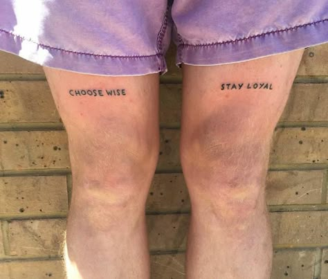 Quote Tattoo Above Knee, Above Knee Text Tattoo, Double Word Tattoo, Knee Writing Tattoo, Knee Tattoos Words, Word Tattoos Men, Knee Word Tattoo, Above Knee Tattoo Words, Over The Knee Tattoo Words