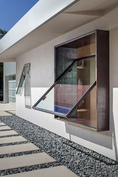 A custom rain-gutter system collects even slight amounts of precipitation in an underground cistern and distributes it to the yard. The Cor-Ten pivoting window is by Brian Linn of Vincent Designs. Pivot Window, Window Design Ideas, Contemporary Window, Modern Window Design, Window Seat Design, House Window Design, Window Architecture, Window Designs, Bow Window