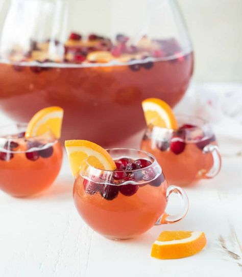 Sparkling Christmas Punch with rum, champagne, cranberry, and apple cider. Easy, refreshing, and perfect for a crowd! Christmas Punch For A Crowd, Dyi Bar, Punch For A Crowd, Easy Christmas Drinks, Wine Punch, Holiday Punch Recipe, Christmas Drinks Alcohol Recipes, Cranberry Punch, Christmas Drinks Alcohol