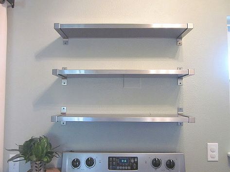 Stainless steel shelving from IKEA Ikea Kitchen Shelves, Wall Mounted Kitchen Shelves, Kitchen Appliances Organization, Stainless Steel Kitchen Shelves, Kitchen Organization Wall, Stainless Steel Shelving, Wall Stove, White Wall Paint, Kitchen Wall Shelves