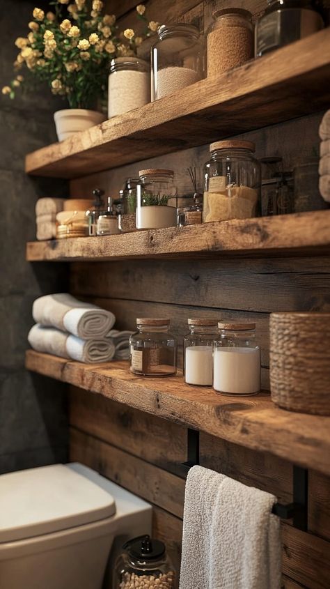 Rustic bathroom with wooden shelves displaying jars and towels, blending warmth and organic beauty in a cozy setting. Wood Shelves Over Toilet, Men’s Bathroom Storage, Rustic Bathroom Shelf Decor, Large Bathroom Shelves, Real Wood Shelves, Rustic Bathroom Shelving, Bathroom Shelving Ideas The Wall, Bathroom Wall Shelving, Woodsy Bathroom