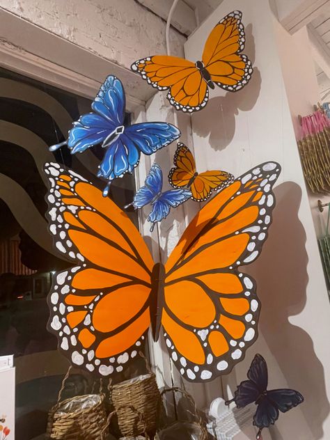 large blue and orange wooden butterflies Spring Decor School, Magnified Vbs Decorations, Magnify Vbs Decor, Magnified Vbs Decor, Lifeway Vbs 2025 Magnified Decorations, Vbs 2025 Magnified, Vbs 2025 Magnified Decorations, Magnified Vbs 2025 Decorations, Butterfly Window Display