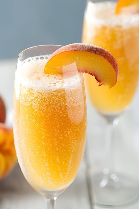 Serve this Bellini recipe for your next party or brunch! The combination of peach puree, Prosecco, and fruit is simple yet elegant. Peach Bellini Recipe Easy, Bellini Recipe Easy, Bellini Cocktail Recipes, Peach Bellini Recipe, Strawberry Bellini, Peach Bellini Cocktail, Frozen Peach Bellini, Manhattan Cocktail Recipe, Michelada Recipe