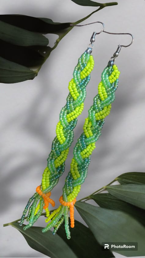 These beaded earrings are a beautiful combination of green beads, made to look like braided sweetgrass. They are the perfect accessory to add a pop of color to any outfit. The intricate beadwork adds a unique touch to these earrings, making them a one-of-a-kind piece of jewelry. The lightweight design makes them comfortable to wear all day long. These earrings are a great addition to any jewelry collection and are sure to be a conversation starter. Beaded Earrings Green, Beaded Earring Tutorials, Native Beaded Jewelry, Dangle Beaded Earrings, Native American Beaded Earrings Pattern, Spring Beaded Earrings, Native Earrings Beaded, Green Beaded Fun Earrings, Green Beaded Earrings For Festival