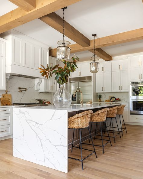 Make a statement by choosing a waterfall edge countertop for your kitchen island! Unlike regular countertops, this design flows seamlessly to the floor, creating a modern, cohesive look.  From luxurious marble to budget-friendly quartz, choose the material that fits your style.  Builder: @southernwoodhomes  Design: @hawkinsandgraydesign  Photos: @lyndseymariephotography Kitchen Peninsula With Waterfall Edge, Modern Kitchen With Waterfall Island, Island Quartz Countertops, Quartz Countertops Waterfall Edge, White Kitchen With Waterfall Island, Kitchen Waterfall Countertop, Waterfall Island Kitchen One Side, Kitchen Ideas Quartz Countertops, Waterfall Kitchen Island Ideas