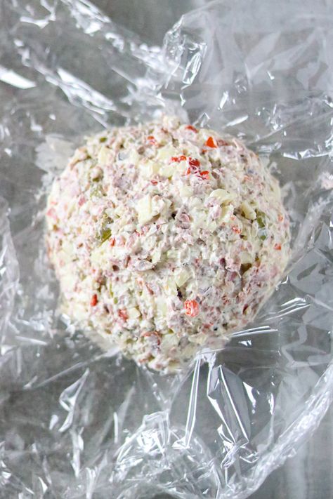 This Muffuletta Cheese Ball tastes like a classic New Orleans muffuletta sandwich. The flavors of salty olives, provolone cheese, and salami go well with cream cheese and Italian seasonings spread on a cracker. It's a quick and easy appetizer, snack food, or party food. Italian Cheese Ball, Muffuletta Sandwich, Appetizers Cheese, Sandwich Cream, Cream Cheese Ball, Italian Seasonings, Mardi Gras Food, Quick And Easy Appetizers, Appetizers Recipes