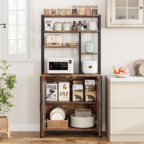 Our versatile 5-Tier Bakers Rack features two spacious open storage shelves, which is ideal for keeping kitchen appliances easily accessible, along with two smaller open shelves designed for neatly organizing bottles and cans. Additionally, the microwave rack is equipped with a convenient grid area and hooks for hanging cups, stirrers, or spoons, providing a practical and efficient storage solution that maximizes space and functionality in your kitchen. Hanging Cups, Microwave Rack, Microwave Storage, Microwave Cabinet, Open Storage Shelves, Coffee Bar Station, Microwave Stand, Utility Shelves, Spice Rack Organiser