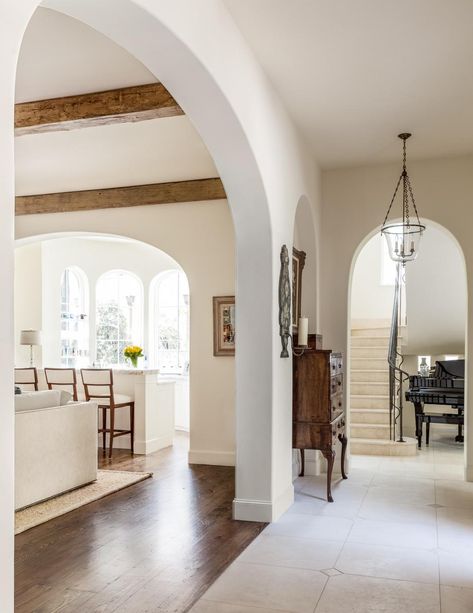 Returning to the entryway, we see the large open living room appearing at left, defined by hardwood flooring. Spanish Style Home Interior, Archways In Homes, Arch Entryway, Arched Doorways, Arch Interior, Spanish Style Home, Open Living Room, Spanish House, Mediterranean Homes