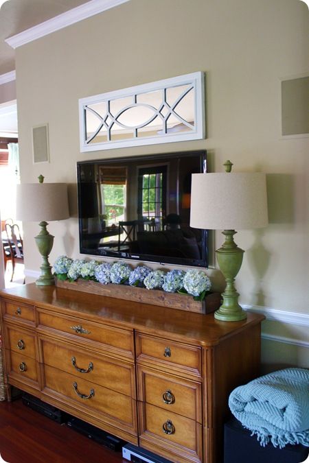 This is exactly how I want the living room to look (only something else besides that mirror above the tv). love the lamps, flower box, lamps and their color!, dresser for the entertainment center, and an ottoman flanking the sides. Perfection Country Thanksgiving, Decor Around Tv, Thrifty Decor Chick, Halloween Centerpiece, Flat Screen Tv, Fall Country, Decor Thanksgiving, Autumn Halloween, Tv Decor