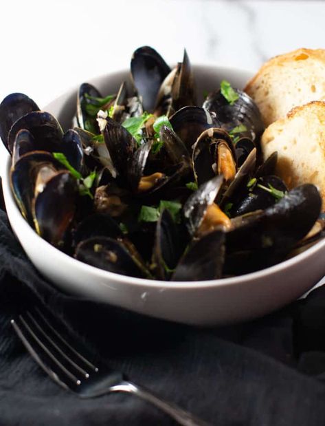 My Mussels in White Wine Sauce recipe is steamed in a delicious butter, white wine and shallot sauce. This is an easy dish or shared an as appetizer. Directions on how to clean and buy mussels are also a part of this article too. #recipe #mussels #whitewine Mussels In White Wine Sauce, Mussels In White Wine, Shallot Sauce, White Wine Sauce Recipes, Cooking Mussels, Steamed Mussels, Mussels Recipe, Easy Seafood, White Wine Sauce