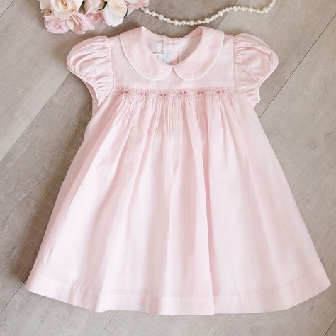 This Little Girls Pink Smocked Dress Is Too Cute!! The Perfect Little Dress For Spring! The Dress Is Done In 100% Cotton. The Peony Pink Hue Is Delightful And A Change From The Usual Pastel Pink. The Peter Pan Collar Is Trimmed In White Piping. The Short Gathered Puff Cap Sleeves Are Also Trimmed In The White Piping. The Front Has A Yoke That Is Bordered With Sweet Smocking. A Lattice Design Is Done In Matching Embroidery And Has Mini-Rosebuds With Green Leaves That Are Spaced Evenly Across The Heirloom Sewing For Babies, Smocking Frocks, Smocking Baby, Pink Toddler Dress, Baby Pink Clothes, Smocked Baby Clothes, Baby Dress Embroidery, Matching Embroidery, Pink Baby Dress