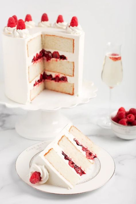 The sophisticated Raspberry Champagne Cake is the perfect way to toast any celebration! Three layers of our fluffy vanilla cake are soaked in French Champagne. Each layer is filled with fresh raspberries, homemade raspberry preserves, and blanketed in our French Champagne vanilla bean buttercream. All topped with fresh Raspberry Champagne Cake, Raspberry Champagne, Fluffy Vanilla Cake, Vanilla Bean Buttercream, Champagne Cake, Birthday Cake Decorating Ideas, Raspberry Preserves, Slow Cooker Desserts, Cake Decorating Ideas