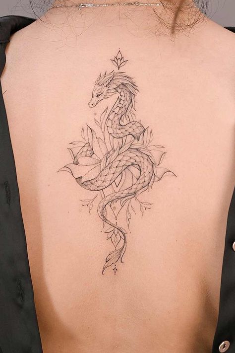 Dragon tattoos symbolize strength, wisdom, and transformation. Explore enchanting designs and unleash your creativity at Glaminati.com. #glaminati #dragontattoo #dragontattoos #femaledragontattoo #dragontattoodesign #tattooideas Dragon Tatoos Woman Back, Aquarius Dragon Tattoo, Dragon Tattoo On Leg Women, Small Dragon Back Tattoo, Idea Tattoo For Women, Futuristic Tattoo Ideas, Wispy Dragon Tattoo, Dragon Ribcage Tattoo, Ornamental Dragon Tattoo