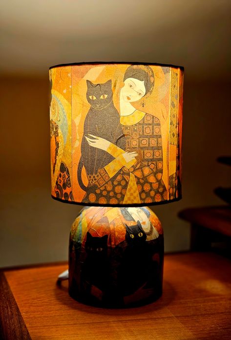 Lovely decoupaged lamp is designed and decoupaged by me (~VerCa~) using Stamperia rice papers presenting beautiful drawings of a lady with a black cat in Klimt's style. The lamp is fully decoupaged shade & stand using high quality stamperia rice paper. The theme is carried on at the lamp stand.  The lampshade is having a lovely relaxing multicoloured shine when you switch it on. The lampshade is decoupaged using decoupage glue and glossy decoupage varnish to make it durable, heatproof and smooth