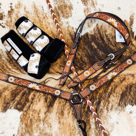 Love the look of the sunflower tack collection but not the color? Rafter T's new daisy collection is a beautiful, neutral alternative. Gorgeous tooling is accented with hand painted details for a stunning look. Fringe Length - 4.5" Note - The tack sets include one headstall and one breast collar. You must select tack set in the drop down to order both pieces. Otherwise you are ordering individual items. The boots and reins are shown for demonstration only and are not included in a tack set purch Tack Sets Western, Barrel Tack Sets, Western Tack Sets Barrel Racing, Horse Bridals Tack, Sunflower Tack Set, Western Tack Sets, Western Riding Tack, Leather Horse Tack, Barrel Racing Tack Rodeo