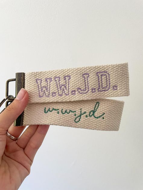 What Would Jesus Do wrist lanyards! These are hand assembled and color- customizable! These are super cute, functional, and an intentional reminder of Faith in action.  ☆ DESCRIPTION  Dimensions: 5" x 1.5" Colors: Choose from 9 colors shown in the last photo. I have more colors available, so if you have your heart set on a certain color/shade, message me and I will show a few options :)  SHIPPING ☆ These keychains are handmade and made to order, making each purchase individually stitched with care. Due to this, I do require a 3-5 day processing time per each order.   For high quantity orders of 4+ items, please allow a 5-7 day processing time. If you have a deadline, please message me upon order and I will make it my priority to expedite the production process! ☆ RETURN POLICY ☆ If you nee Handmade Christian Gifts, Christian Gifts For Him, Christian Products, Key Chain, Key Chains, Wwjd Hwlf Bracelet, Christian Keychain Ideas, Christian Wristlet Keychain, Wwjd Keychain