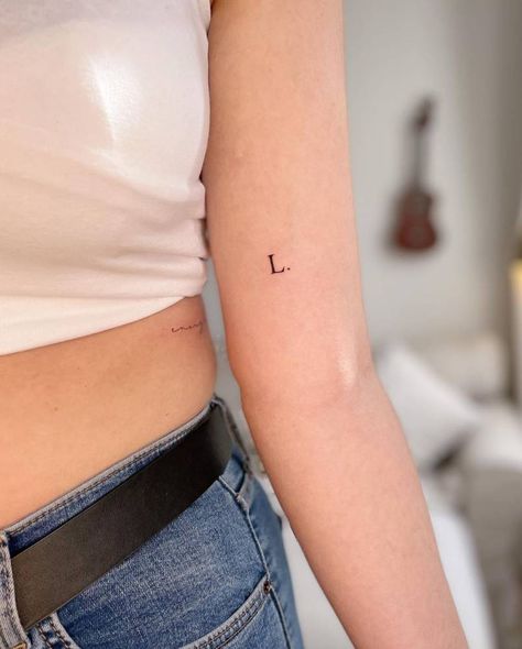 Typewriter Letter Tattoo, Typewriter Font Tattoo Initials, Letter Tattoo Placement Ideas, Child Initial Tattoo Ideas, Minimalist Initial Tattoo, Letter Arm Tattoo, Letter Fonts For Tattoos, L Initial Tattoo, L Tattoo Letter