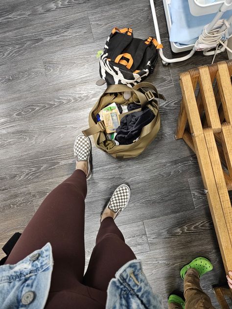 Feet wearing neutral checkered vans and brown yoga pants. The feet stand next to an open army green tote overflowing with snacks, a wallet and essentials. Brown Checkered Vans Outfit, Brown Vans Outfit, Checkered Vans Outfit, Brown Vans, Brown Checkered, Mom Wardrobe, Vans Outfit, Checkered Vans, Fall Style