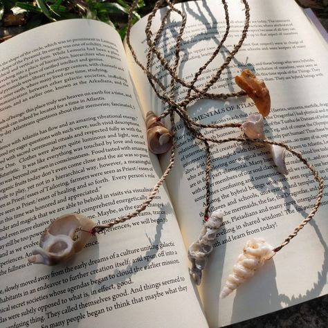 Six seashell bookmarks scattered on an open book in an abstract pattern Seashell Bookmarks, Illustrated Journal, Pressed Flowers Diy, Banana Fiber, Shot Book, Agate Rocks, Spiral Shell, String Crafts, Handmade Bookmarks