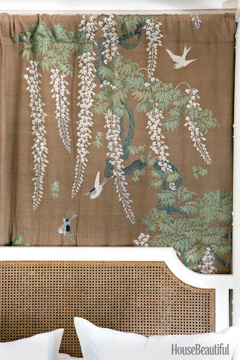 A 1920s Japanese hand-embroidered curtain panel from a Pasadena estate hangs behind the cane headboard on the four-poster in the master bedroom.   - HouseBeautiful.com Cozy Beach Cottage, Embroidered Curtains, Cottage Makeover, Peter Dunham, Herringbone Wallpaper, Los Angeles Interior Design, Stucco Homes, Mediterranean Style Homes, Iron Coffee Table