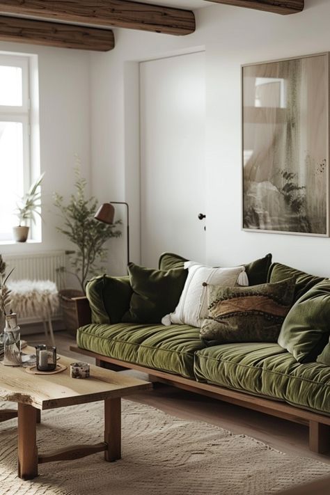 With a focus on functionality and minimalism, Scandinavian living rooms use neutral tones for a clean, calming feel. Click to see more. Green Couch Cottage, Copenhagen Living Room, Mid Century Scandinavian Living Rooms, Warm Scandinavian Living Room, Warm Scandinavian Interior, Scandi Minimalist Home, Scandinavian Living Room Nordic Style, Small Living Room Sofa, Minimalist Scandinavian Living Room