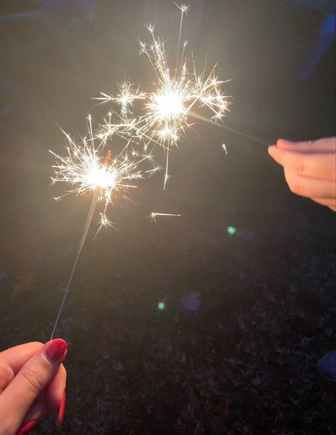 Two people holding sparklers at night Beach Sparklers, Sparklers On The Beach, Photoshoot With Sparklers, Sparkler Photos, Birthday Sparklers Aesthetic, Sparklers Aesthetics, Wedding Fireworks Sparklers, Couple Sparkler Pictures, Quirky Photography