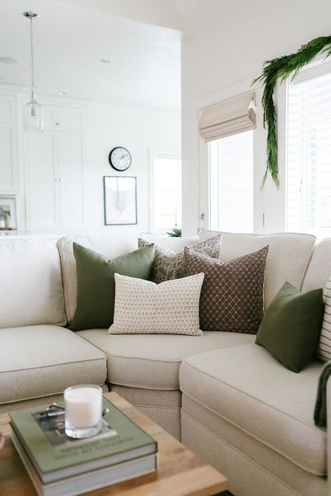 Green Living Room Christmas Decor, Spring Cushions Living Rooms, Living Room Green Pillows, White Living Room With Green Accents, Cream Sofa Green Cushions, Beige Couch Green Pillows, Nuetral Pallete Living Room With Green, Cream And Sage Green Living Room, Sage Green Pillows Living Room