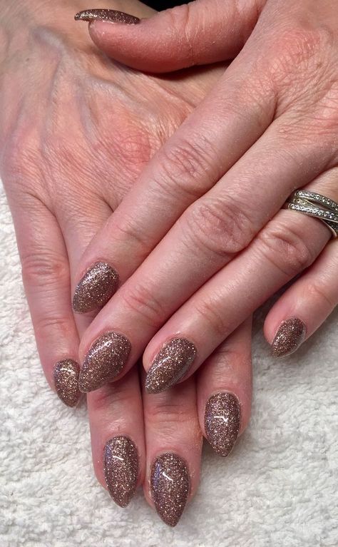 If you’re on Instagram, you’ve definitely seen this “velvet” nail trend on your feed. Basically, it involves a few coats of hyper-shimmery polish, followed by a magnet to... read more Chocolate Sparkle Nails, Brown Glitter Nails Acrylic, Glitter Nails Brown, Brown Nails Sparkle, Bronze Glitter Nails, Glitter Brown Nails, Brown Holiday Nails, Brown Glitter Nails Fall, Sparkly Brown Nails