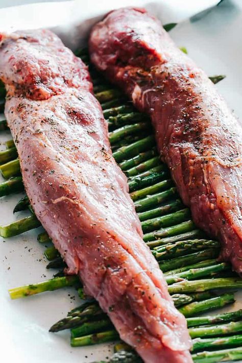 One Pan Roasted Pork Tenderloin with Asparagus - The ease of one pan and the delicious flavors of pork paired with asparagus make this recipe a wonderful meal that results in an incredible, tender and juicy dinner in just 30 minutes. An effortless meal perfect for busy weeknights, but also fancy enough for a Holiday dinner. #pork #porktenderloin #holidays #christmas #christmasdinner #asparagus #onepanmeal #dinnerrecipes Asparagus Stuffed Pork Tenderloin, Pork Tenderloin And Asparagus Recipes, Pork And Asparagus Recipes, Roasted Pork Tenderloin Recipes, Dinner Pork, Juicy Pork Tenderloin, Roasted Pork Tenderloin, Crockpot Pork Tenderloin, Cooking Pork Tenderloin