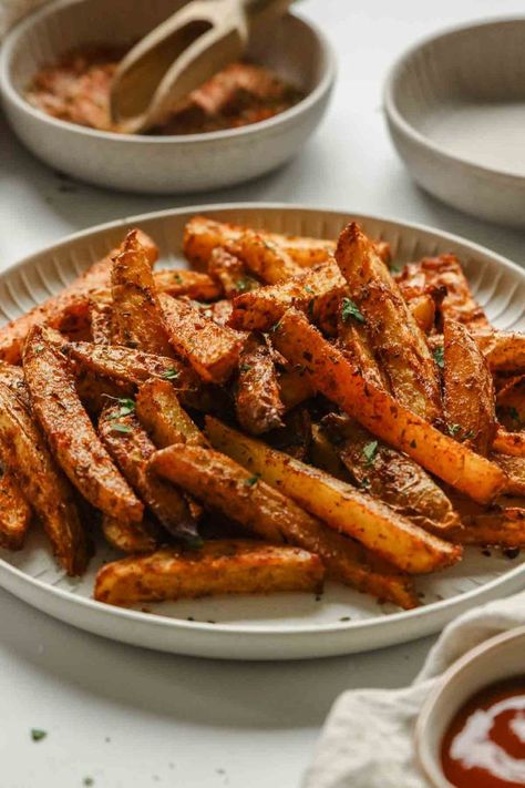 close up of oven baked cajun fries on white plate Healthy Cajun, Cajun Fries, Cajun Seasoning, Healthy Side Dishes, Food Illustrations, Oven Baked, Deep Fried, Dipping Sauce, Side Dish Recipes