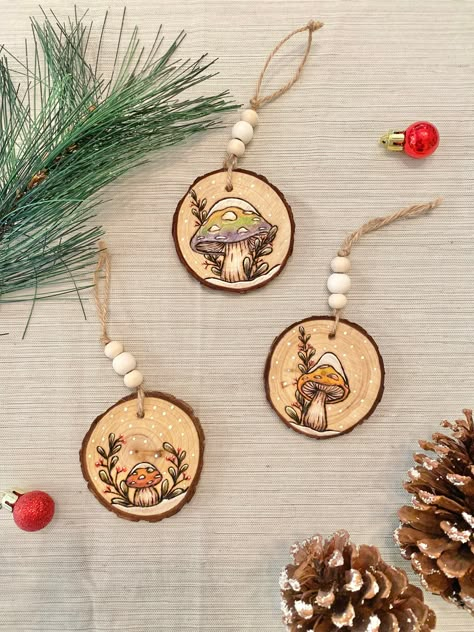 These adorable handmade ornaments will add a colorful touch to any tree! They are available individually or as a set of 3 - just choose your selection when you add it to your cart. They are wood-burned by hand, colored, and finished off with an eco-friendly wood seal to ensure heat protection and a long lasting product. Each ornament varies between 2-3 inches. Yule Wood Ornaments, Wooden Disc Christmas Ornaments, Painted Wood Mushrooms, Christmas Ornaments Homemade Wood, Wood Burn Christmas Ornaments, Wood Burned Christmas Ornaments, Woodburn Ornaments, Pyrography Ornaments, Wood Burning Ornaments