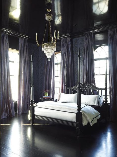 Stunning French bedroom boasts a glossy black painted ceiling over walls clad in purple and black damask wallpaper lined with a black French poster bed dressed in white and black hotel duvet and shams layered over a black sheet set atop ebony floors flanked by windows dressed in purple curtains hung high with drapery hardware hidden behind glossy black cornice boxes illuminated by a tiered crystal chandelier. Holiday Bedding, Quilts Christmas, Royal Bed, Christmas Duvet, Gothic Interior, Small Lounge, Gothic Bedroom, Victorian Bedroom, Moody Bedroom