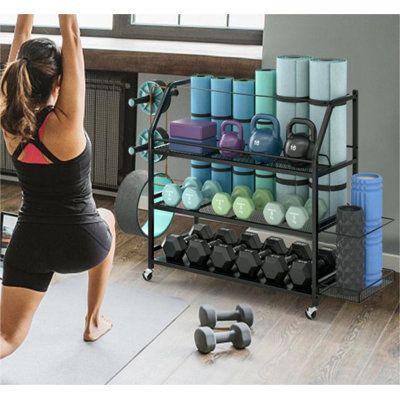 The sturdy sports storage rack is a convenient and ideal option for organizing your yoga equipment. It has three wide open shelves and two extra side storage areas, which should provide ample space for storing workout mats and other common sports accessories. | Arlmont & Co. Home Gym Storage Rack Black 36.0 x 54.0 x 15.0 in, Metal | Organization | C011141215 | Wayfair Canada Workout Clothes Organization, Gym Bag Storage, Home Gym Storage Ideas, Gym Storage Ideas, Gym Organization Ideas, Gym Organization, Sports Equipment Organization, Garage Storage Plans, Home Gym Storage